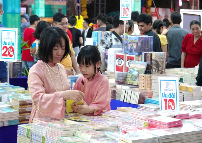 Lễ hội Đường sách Tết Bính Ngọ 2026 đạt doanh thu gần 8,2 tỷ đồng 4 Mẹ chọn sách hay cho con trong ngày đầu năm mới. Ảnh: THÚY BÌNH